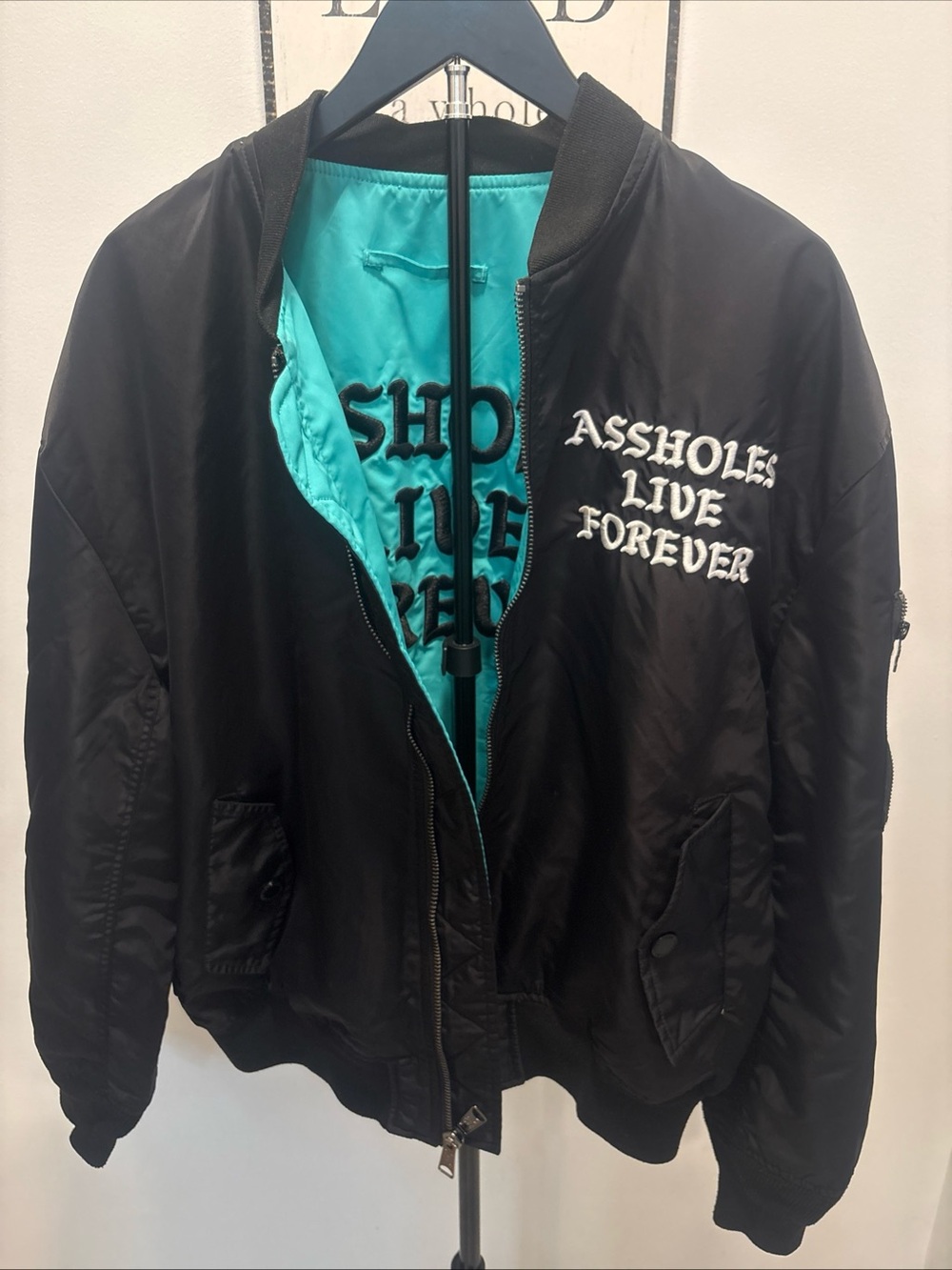 Black Bomber Jacket with Teal Lining and White Script Chest